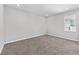 Bright bedroom featuring neutral walls, carpet flooring and a window with a view to the outside at 5714 Sw 75Th Ave, Ocala, FL 34474