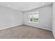 Bright bedroom featuring neutral walls, carpet flooring and a window with a view to the outside at 5714 Sw 75Th Ave, Ocala, FL 34474