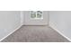Bedroom with neutral walls and plush carpeting with window offering natural light at 5714 Sw 75Th Ave, Ocala, FL 34474