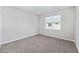 Bright bedroom with neutral walls, carpet, and natural light from a large window at 5714 Sw 75Th Ave, Ocala, FL 34474