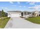 Inviting single-story home featuring a two-car garage, cozy covered porch, and a beautifully landscaped front yard at 5714 Sw 75Th Ave, Ocala, FL 34474