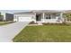 Attractive single-story home boasting a two-car garage, inviting covered porch, and a verdant lawn at 5714 Sw 75Th Ave, Ocala, FL 34474