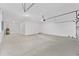Spacious garage with concrete flooring, white walls and overhead garage door at 5714 Sw 75Th Ave, Ocala, FL 34474