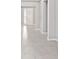 Bright hallway with tile flooring, leading towards a white front door, with neutral gray walls at 5714 Sw 75Th Ave, Ocala, FL 34474