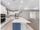 Modern kitchen boasts an island with quartz countertops and stainless steel appliances at 5714 Sw 75Th Ave, Ocala, FL 34474