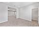Open concept living room with carpet and neutral tones, great for versatile living spaces at 5714 Sw 75Th Ave, Ocala, FL 34474