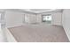 Open living room with plush carpeting, neutral walls, and sliding glass doors leading to the outdoors at 5714 Sw 75Th Ave, Ocala, FL 34474