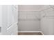 Walk-in closet featuring door, wire shelving, and neutral carpeting for storage at 5714 Sw 75Th Ave, Ocala, FL 34474