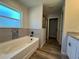 Bright bathroom features a soaking tub and tiled walls at 5799 Sw 207Th Ct, Dunnellon, FL 34431