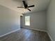 Cozy bedroom features a ceiling fan, natural light, and modern flooring for comfortable living at 5799 Sw 207Th Ct, Dunnellon, FL 34431