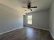 A spacious bedroom featuring wood flooring and natural light at 5799 Sw 207Th Ct, Dunnellon, FL 34431