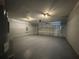 The spacious garage boasts a clean, painted floor and an automatic door opener at 5799 Sw 207Th Ct, Dunnellon, FL 34431