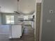 Open concept kitchen with island, granite countertops, stainless steel appliances, and gray flooring at 5799 Sw 207Th Ct, Dunnellon, FL 34431