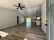 Spacious living room with luxury vinyl plank flooring and modern ceiling fan, great for entertaining at 5799 Sw 207Th Ct, Dunnellon, FL 34431