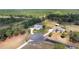 Bird's eye view of a well-manicured property with circular driveway, mature landscaping, and a light-colored home nestled among trees at 5819 Ne 72Nd St, Silver Springs, FL 34488
