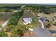 A high-angle view showcases a lovely home with an in-ground pool and picturesque landscaping at 5819 Ne 72Nd St, Silver Springs, FL 34488