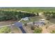 Overhead perspective of a beautifully maintained property with landscaping, circular driveway, and an appealing, light-colored house at 5819 Ne 72Nd St, Silver Springs, FL 34488
