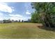 Expansive backyard space with a screen-enclosed porch and mature trees, perfect for enjoying nature and outdoor activities at 5819 Ne 72Nd St, Silver Springs, FL 34488