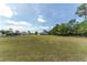A sprawling backyard features mature trees, fencing, and plenty of green space, creating a private oasis for outdoor enjoyment at 5819 Ne 72Nd St, Silver Springs, FL 34488