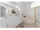 Bright bathroom features a double sink vanity, soaking tub, and a shower with gold trim at 5819 Ne 72Nd St, Silver Springs, FL 34488
