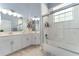 Bright bathroom featuring a double vanity, tiled floor, shower-tub combo, and blue accents at 5819 Ne 72Nd St, Silver Springs, FL 34488