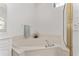 Bathroom features a soaking tub with chrome faucet and shower with gold trim at 5819 Ne 72Nd St, Silver Springs, FL 34488