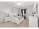 Cozy bedroom featuring carpet floors, a queen bed, and bright gray walls at 5819 Ne 72Nd St, Silver Springs, FL 34488