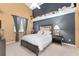 Bright bedroom featuring a vaulted ceiling, cozy bed, and playful decor atop a dark blue accent wall at 5819 Ne 72Nd St, Silver Springs, FL 34488