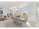 Dining room with large arched window, chandelier, table with seating for eight, and living room at 5819 Ne 72Nd St, Silver Springs, FL 34488