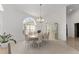 Bright dining room features an elegant chandelier, large windows, and a china cabinet at 5819 Ne 72Nd St, Silver Springs, FL 34488