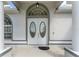 Close-up of the front door with decorative glass inserts and an arched transom window at 5819 Ne 72Nd St, Silver Springs, FL 34488