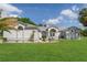 Beautiful one-story home with a well-manicured lawn, fresh landscaping and a welcoming double-door entrance at 5819 Ne 72Nd St, Silver Springs, FL 34488