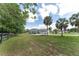 Side view of a well-maintained home featuring an attached two-car garage, long driveway, and spacious backyard at 5819 Ne 72Nd St, Silver Springs, FL 34488