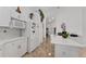 Open kitchen featuring white appliances, cabinetry, tile floors, and ample counter space at 5819 Ne 72Nd St, Silver Springs, FL 34488