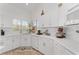Bright kitchen featuring white cabinetry, countertops, and stainless steel appliances at 5819 Ne 72Nd St, Silver Springs, FL 34488