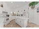 Well-lit kitchen featuring an island, white cabinetry, and stainless steel appliances at 5819 Ne 72Nd St, Silver Springs, FL 34488