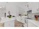 An open white kitchen featuring an island, tile floor, and modern appliances at 5819 Ne 72Nd St, Silver Springs, FL 34488