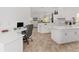 Bright kitchen with white cabinetry, tile flooring, and a work desk at 5819 Ne 72Nd St, Silver Springs, FL 34488