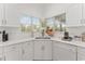 Bright kitchen with white cabinets, stainless steel appliances, and a tile backsplash at 5819 Ne 72Nd St, Silver Springs, FL 34488