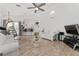 Spacious living room featuring tile floors, comfortable seating, and a modern ceiling fan at 5819 Ne 72Nd St, Silver Springs, FL 34488