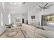 Open concept living room leading to the dining area, featuring high ceilings and a sleek white sofa at 5819 Ne 72Nd St, Silver Springs, FL 34488