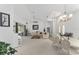 Living room with dining area, piano, vaulted ceiling, and access to the outdoor patio at 5819 Ne 72Nd St, Silver Springs, FL 34488