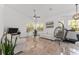 A modern living room with high ceilings, neutral tones, and natural light at 5819 Ne 72Nd St, Silver Springs, FL 34488