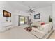 Bright living area with a white piano, comfortable seating, and sliding glass doors to the patio at 5819 Ne 72Nd St, Silver Springs, FL 34488