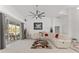 Spacious living room featuring a modern fan, neutral décor, and sliding glass doors to the backyard at 5819 Ne 72Nd St, Silver Springs, FL 34488