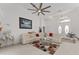 Open-concept living space with high ceilings, modern fan, and views of the front door and dining area at 5819 Ne 72Nd St, Silver Springs, FL 34488