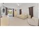 Spacious main bedroom with a bed, closet, and sliding glass door to a private outdoor space at 5819 Ne 72Nd St, Silver Springs, FL 34488