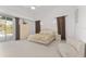 Bright main bedroom featuring a bed, closet, and sliding glass door to a private outdoor space at 5819 Ne 72Nd St, Silver Springs, FL 34488