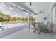 A covered patio includes a ceiling fan and views of a screened-in pool at 5819 Ne 72Nd St, Silver Springs, FL 34488