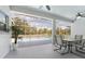 A covered patio includes a ceiling fan and views of a screened-in pool at 5819 Ne 72Nd St, Silver Springs, FL 34488